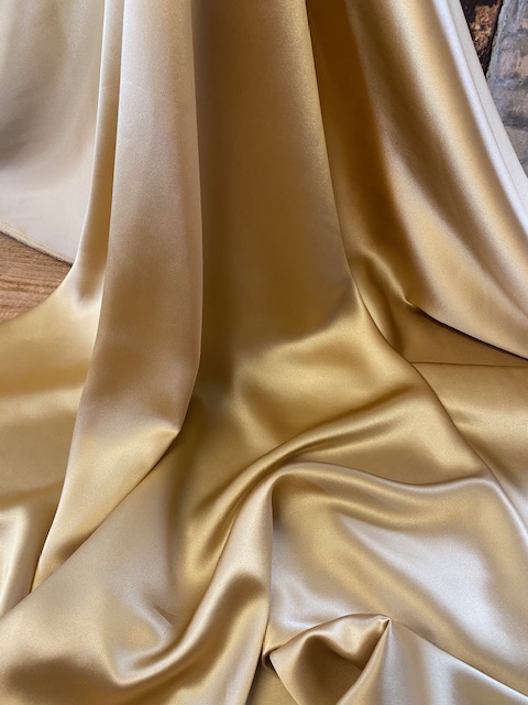 Pure silk satin in a beautiful gilt colour $89 metre and 137cm wide.
